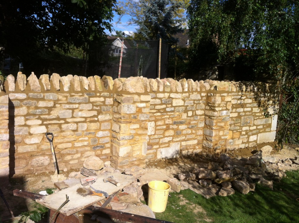 A garden boundary wall totally rebuilt and now structurally sound